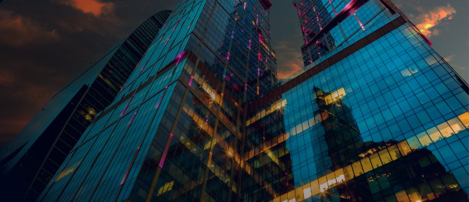 Modern skyscraper with colorful lighting against a dark sky